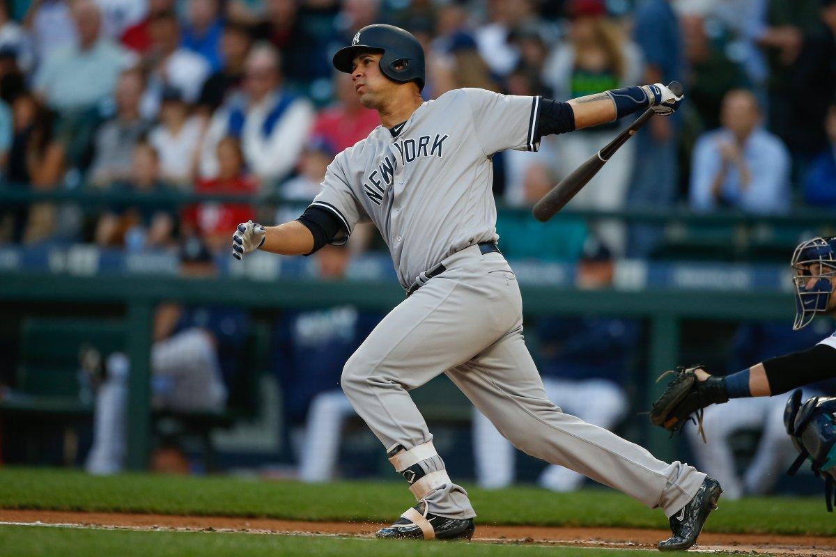 Yankees star catcher Gary Sanchez taking a swing at the plate.