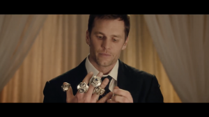 NFL star Tom Brady and his Super Bowl Rings in a Super Bowl commercial.