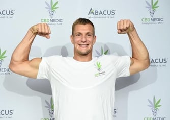 A photo of NFL star Rob Gronkowski at an event with his CBD sponsor.